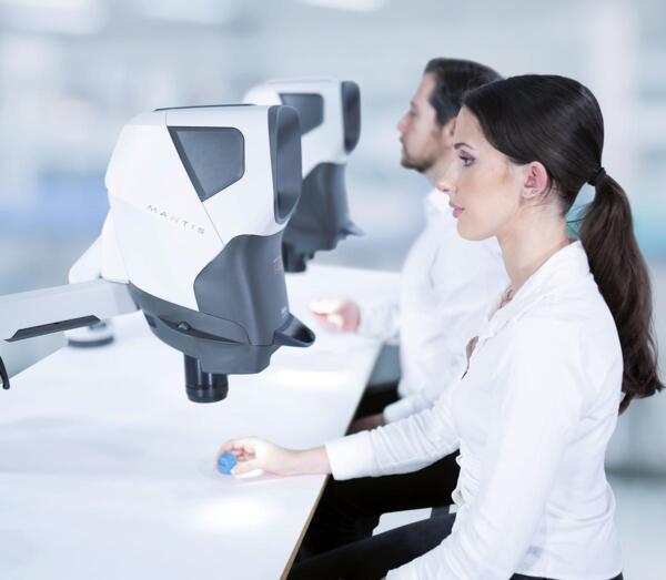 Two-people-using-Mantis-inspecting-plastic-600×523 Dental technicians inspecting dental moulds using Mantis stereo microscope